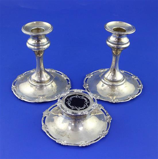 A pair of George V silver desk dwarf candlesticks and a matching silver inkwell with tortoiseshell and silver pique lid,